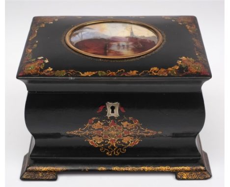 A 19th century papier mache lacquer tea caddy: the hinged lid inset with an oval painted scene of a riverside church and brid