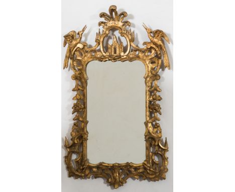 A 19th century carved giltwood wall mirror: of cartouche-shaped outline with palmette and ho-ho bird cresting centred by a pi