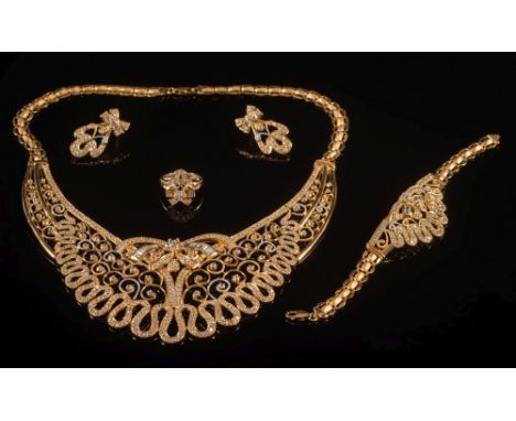 A suite of gem-set  jewellery: of scroll open work design comprising a collar necklace, a pair of earrings, a cluster ring an