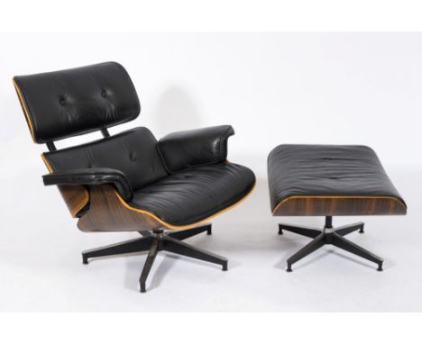 A coromandel finish and black vinyl button back armchair: in the style of Eames on blackened finish revolving base, together 