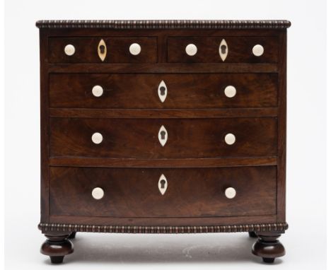 An apprenticeman's early 19th century mahogany bow-fronted chest: with reel turned mouldings and ivory button handles and nav