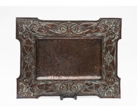 An Arts and Craft period copper tray: of rectangular outline, the border decorated with Celtic dragons and briar roses, 59cm.