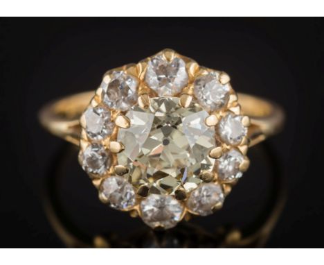 A light yellow diamond and diamond circular cluster ring:, the central light yellow round old brilliant-cut diamond approxima
