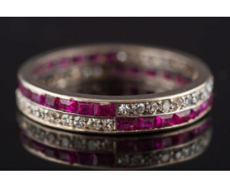 A 1930's ruby and diamond full eternity ring: with calibre-cut rubies and circular diamonds, pave-set in parallel rows altern