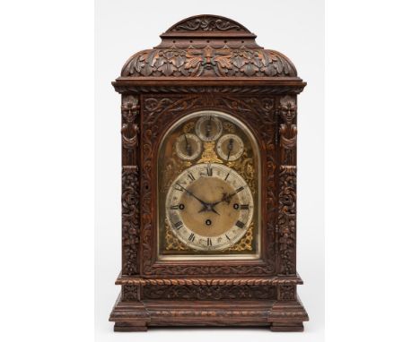 A Victorian carved oak chiming bracket clock: the eight-day duration, triple-fusee movement striking the hours on a gong and 