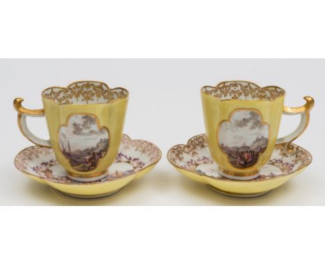 A pair of Meissen yellow-ground quatrefoil cups and saucers: painted with gilt and puce bordered cartouches depicting busy ha