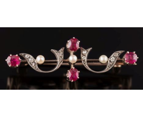 A late 19th century gold, silver, ruby and diamond bar brooch: of openwork scroll design.