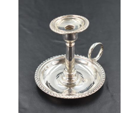 A late Victorian silver miniature chamber stick, of traditional design with gadrooned edge decoration, the pan engraved 'This