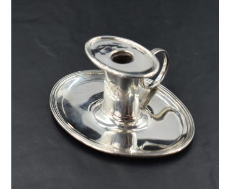 A George III silver 'Go to Bed' miniature chamber stick, of oval form with lift out broad rimmed sconce, plain column engrave