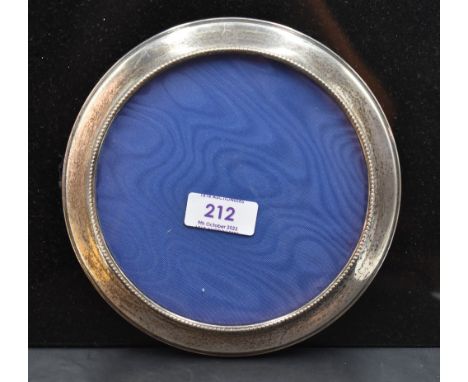 A modern silver mounted circular photograph frame, with beaded inner edge detail, wall mounting bracket to reverse, marks for