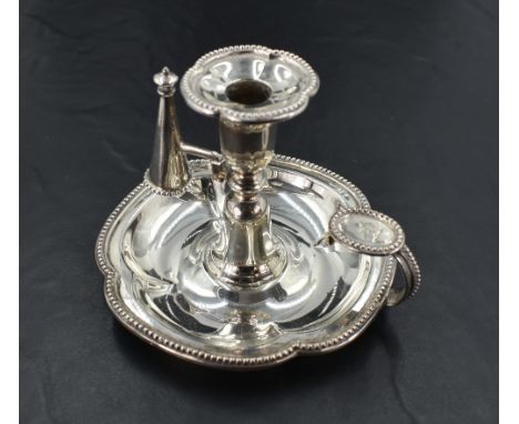 A Victorian silver chamber stick, of lobed circular form with bead moulded edge detail, having a removable sconce and snuffer