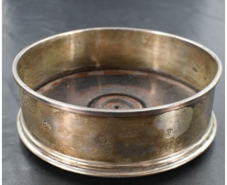 An Elizabeth II silver wine coaster, of circular form with moulded rims and stained and turned mahogany base, marks for Londo