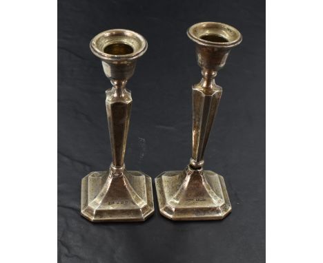 A pair of silver candlesticks, of fluted and tapering form, marks for Birmingham 1913, maker S&amp;Co most likely Sydney &amp