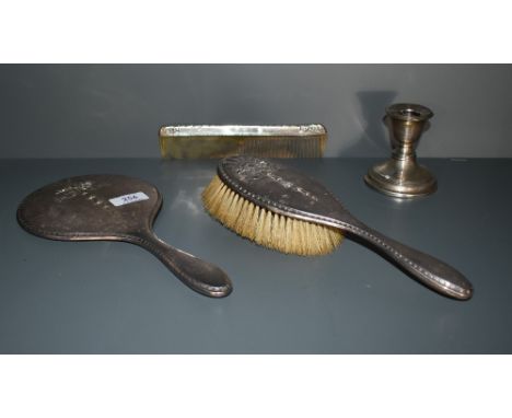 A George V silver mounted three piece brush set, comprising comprising hair brush, hand mirror and comb, the silver mounts em