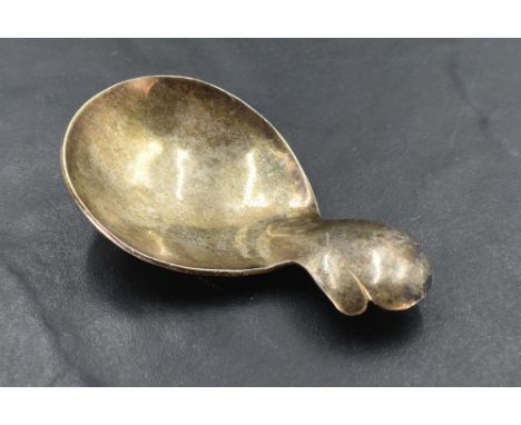 An Elizabeth II silver caddy spoon, having broad oval bowl and short trefoil handle, marks for Chester 1957, maker Arthur Cre