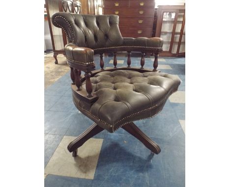 A Leather Upholstered Serpentine Front Swivel Office Chair with Button Seat and Back Rest.