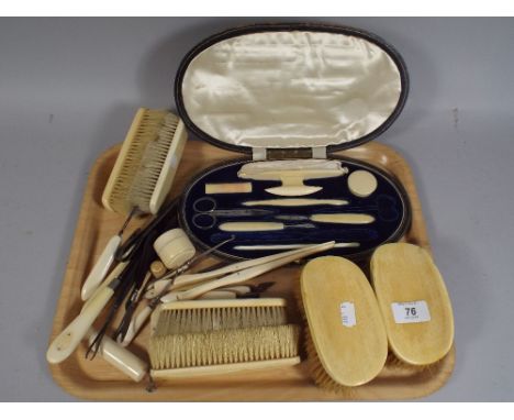 A Collection of Early 20th Century Ivory Brushes, Button Hooks, Glove Stretchers and Manicure Set.