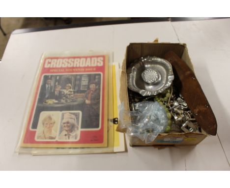 A box of costume brooches and necklaces; a lighter etc. 