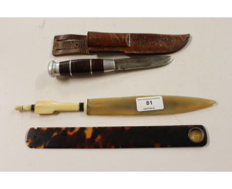 A faux tortoiseshell and coin inset page turner;a small knife in brown leather scabbard; and a letter opener