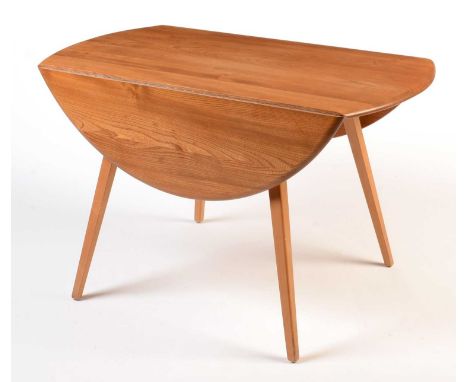 Ercol: a light beech and elm round-shaped drop-leaf dining table, Model 384, 123 (open) x 113 x 73cms high.