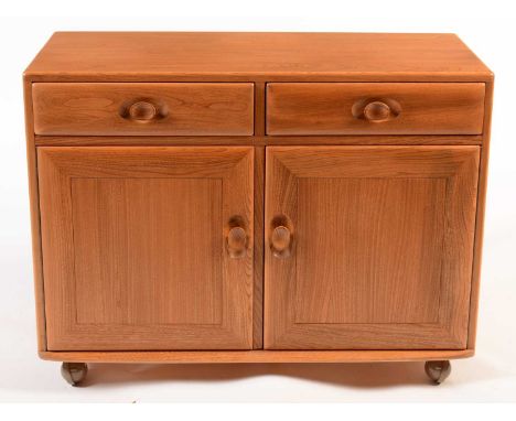 Ercol: a light elm side cabinet, the rectangular top above two short drawers, a pair of cupboard doors below enclosing an adj