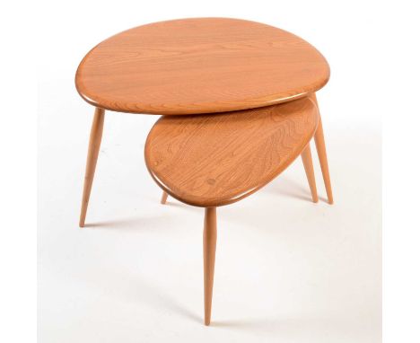 Ercol: two (from a nest of three) occasional tables, in light beech and elm, Model 354, the larger 55 x 44 x 40cms.