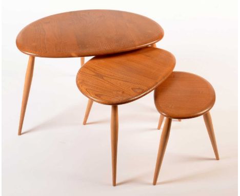 Ercol: a light elm and beech nest of three tables, in the 'Windsor' No. 354 pattern, largest 64 x 44 x 40cms high.