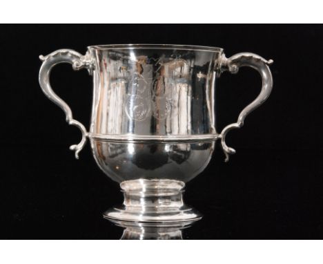 A George III hallmarked silver twin handled loving cup of plain form within engraved initials to either side below a heart mo
