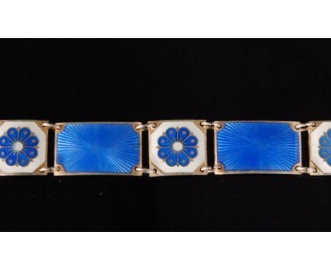 A Norwegian silver gilt and enamel panel link bracelet formed of six rectangular blue guilloche enamelled links, spaced by fi