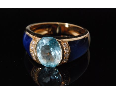 A 20th Century French 18ct blue topaz and diamond ring with central oval cut pale blue topaz, collar set and bordered by eigh