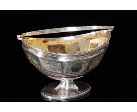 A George III hallmarked silver sugar basket of oval outline with faceted frieze panel with bright cut decoration below a reed