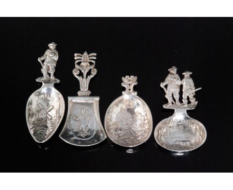 Four early 20th Century German silver novelty caddy spoons each with engraved figural, windmill or landscape scenes, import m