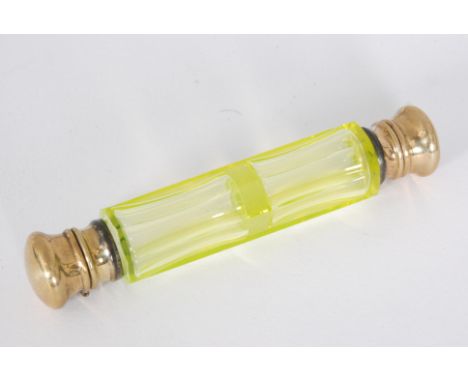 An early 20th Century double ended scent bottle, the slice cut uranium yellow cylindrical glass bottle with gilt metal domed 