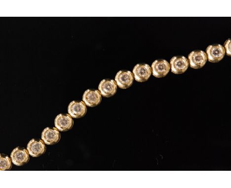 A contemporary 18ct diamond tennis bracelet, formed of thirty one brilliant cut diamonds each within a circular surround to a