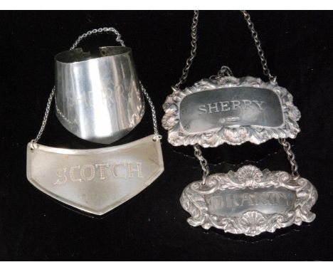 Two hallmarked silver, a sterling silver and a white metal decanter label, Sherry, Brandy, Scotch and Sherry respectively. (4