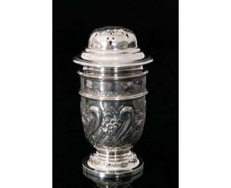 An Edwardian hallmarked silver sugar caster of tapering cylindrical form, embossed with foliate scroll work decoration below 