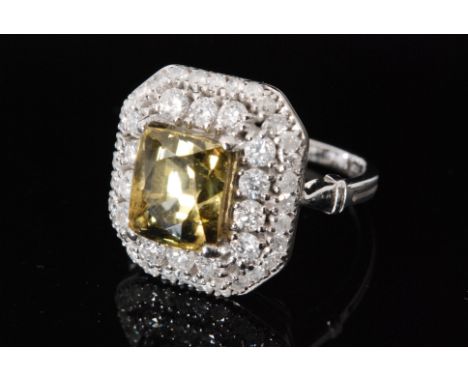 An 18ct white gold zultanite and diamond cluster ring central radiant cut zultanite within fourteen brilliant cut diamond sur