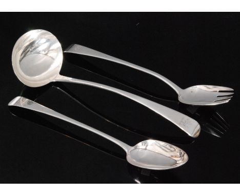 A George III hallmarked silver old English pattern basting spoon, six tined serving spoon and a soup ladle each with lion cre