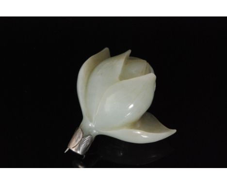 A 20th Century carved jade coloured brooch modelled as an opening lotus flower to a silver mount, length 5.5cm. 