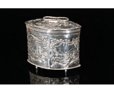 An early 20th Century hallmarked silver Dutch export tea caddy of ovoid outline with all over embossed decoration depicting f