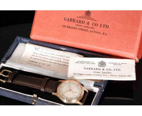 A 1950s hallmarked 9ct Garrard gentleman's manual wind wristwatch, of circular outline with champagne dial, Arabic numerals a