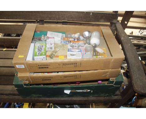 Three boxes containing various light bulbs and a children's toy