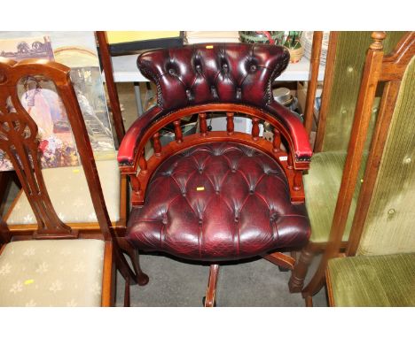 A reproduction red leatherette and button back upholstered Captain style chair