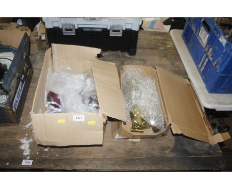 A box containing two wall lights and a box of vintage engraved glass baubles