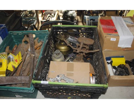 A plastic crate with contents including oil lamp, scale & weights, other hand tools