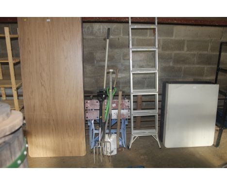 A quantity of gardening tools to include digging fork, spade, sledge hammer, builders workmate etc.