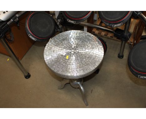 A decorative modern tripod occasional table