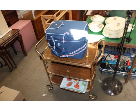 A reproduction tea trolley; a camera tripod and a collection of various bags
