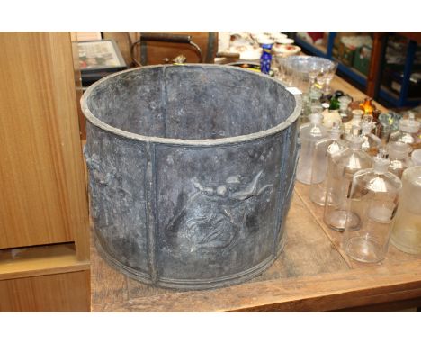 A lead planter decorated with maidens and cherubs approx. 30cm high and 41.5cm diameter