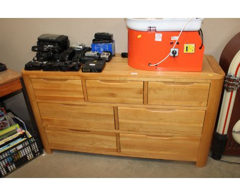 A modern light oak chest fitted three short over four long drawers 